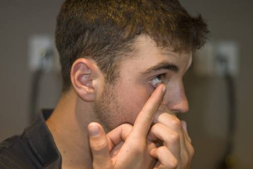 man removing contact